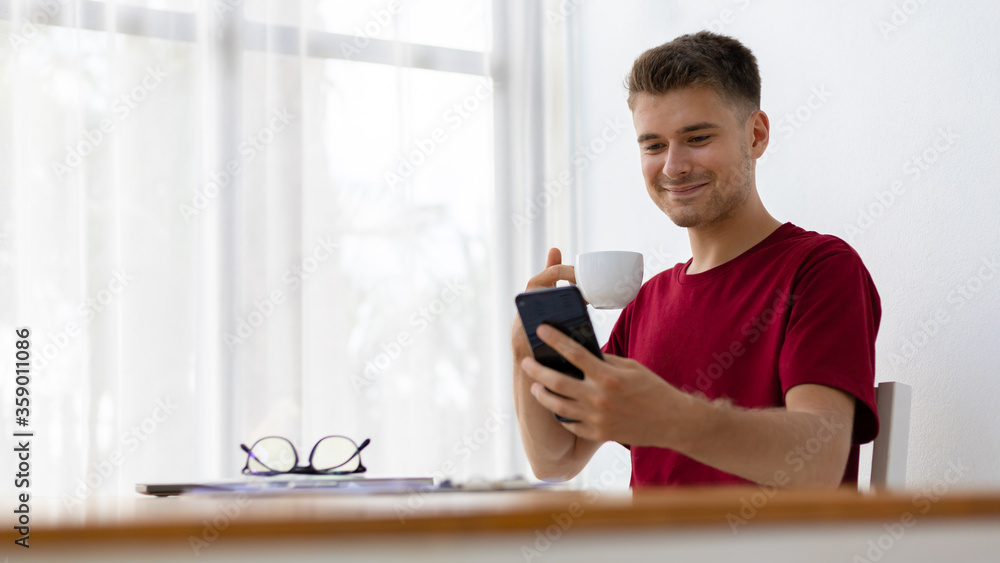 Happiness man drinking coffee and using smartphone Happiness man drinking coffee and using smartphone
