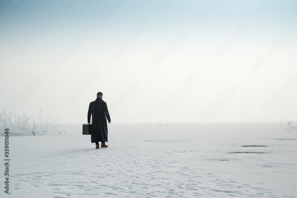 man  walking in winter