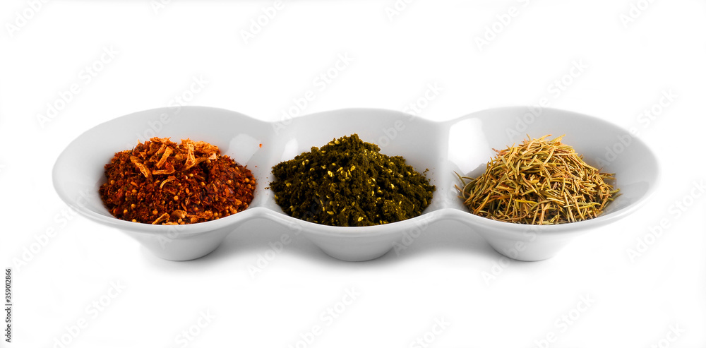 spices in white plates on white background spices in white plates on white background