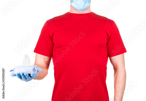 Man in red t-shirt, medical mask and gloves holding wet wipes or tissue isolated