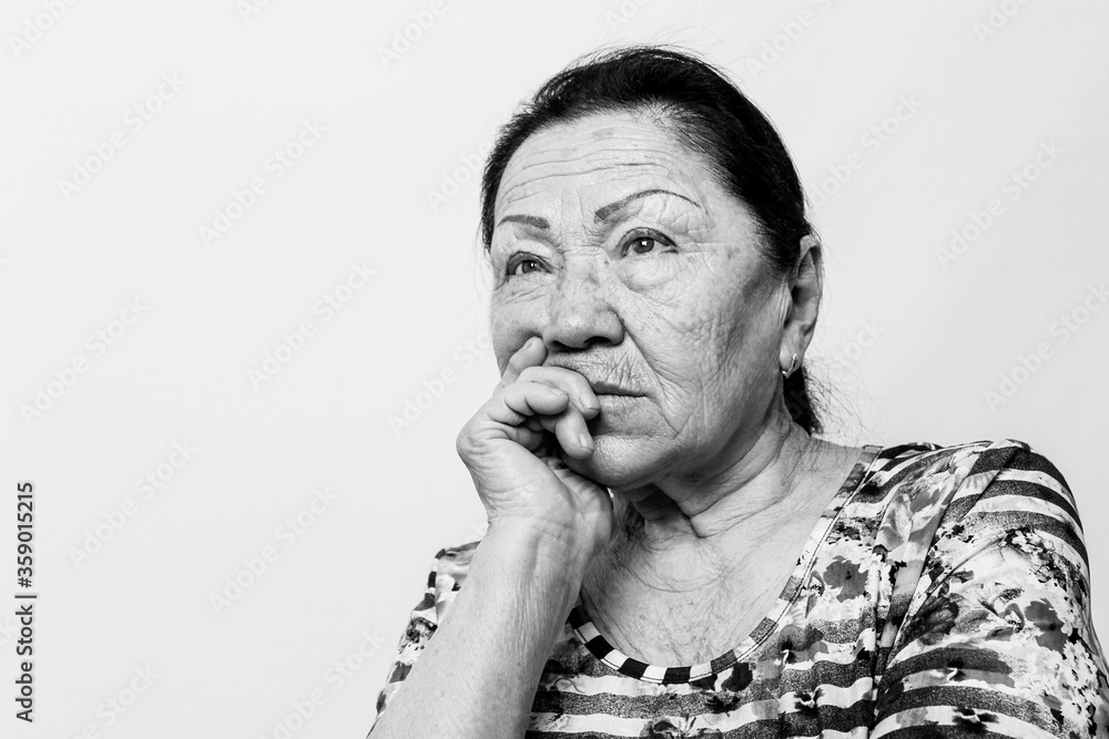 Obraz premium Portrait of elderly senior woman, back and white photo. Thinking about passed years. Loneliness, solitude. Black and white photo.