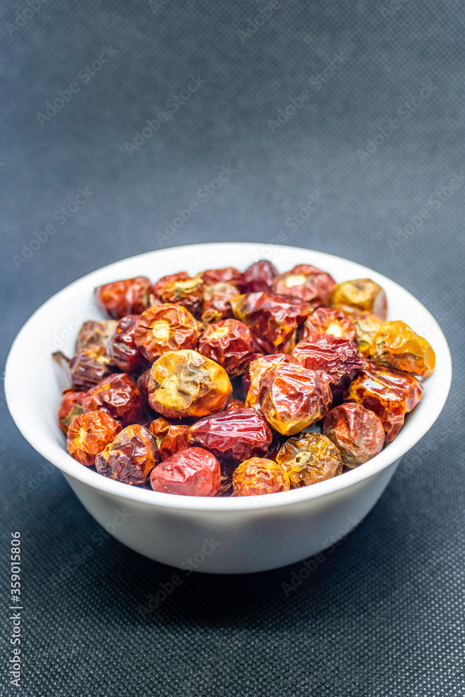 a bunch of round red chillies in a white bowl a bunch of round red chillies in a white bowl