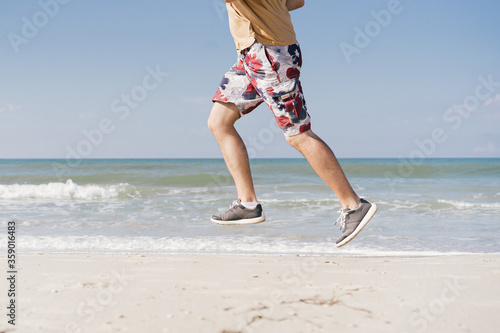 man on the beach near the sea does a jogging training 