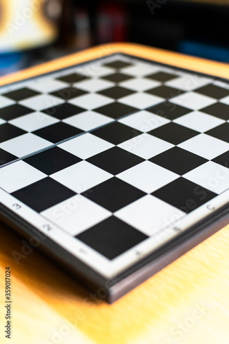 a chess board on a table, Selective focus, Selective focus on subject, background blur