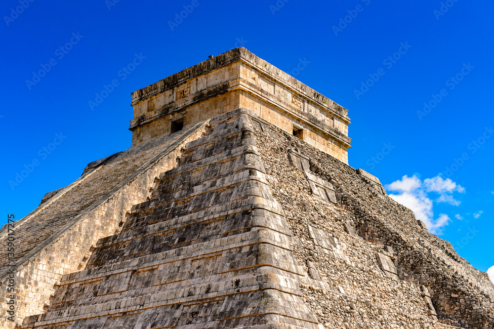 El Castillo (Temple of Kukulcan), a Mesoamerican step-pyramid, Chichen Itza. It was a large pre-Columbian city built by the Maya people of the Terminal Classic period. UNESCO World Heritage El Castillo (Temple of Kukulcan), a Mesoamerican step-pyramid, Chichen Itza. It was a large pre-Columbian city built by the Maya people of the Terminal Classic period. UNESCO World Heritage