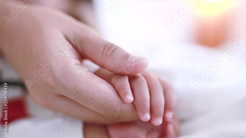 Soft focus of baby hands and mom, New family and baby protection concept, baby in the hand of mother close up, Parent holds Baby Hand Closeup