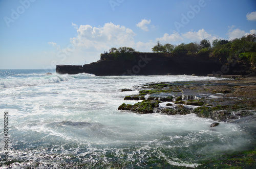 Tanah Lot is a rock formation off the Indonesian island of Bali. It is home to the ancient Hindu pilgrimage temple Pura Tanah Lot, a popular tourist and cultural icon for photography.