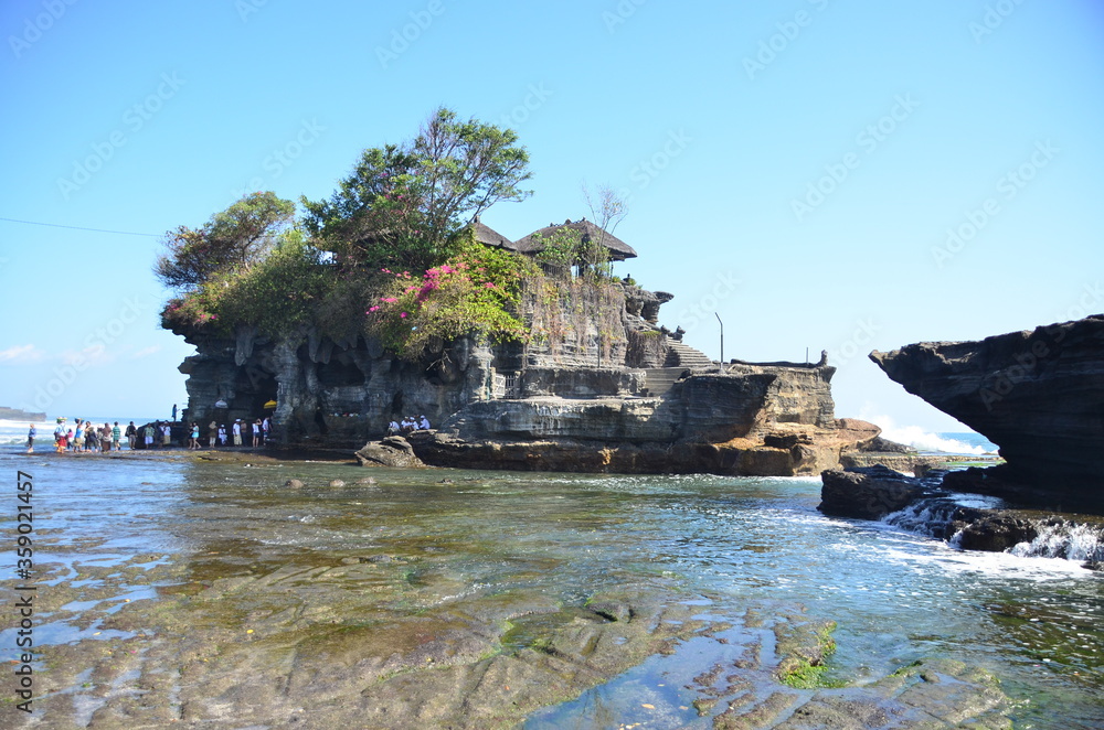 Tanah Lot is a rock formation off the Indonesian island of Bali. It is home to the ancient Hindu pilgrimage temple Pura Tanah Lot, a popular tourist and cultural icon for photography. 