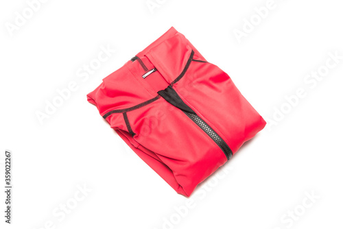 Folded red zipper windbreaker jacket, UV sun proof outdoor jacket hoodie. Track jacket sport hoodie full zip isolated on white background. Folded clothes.