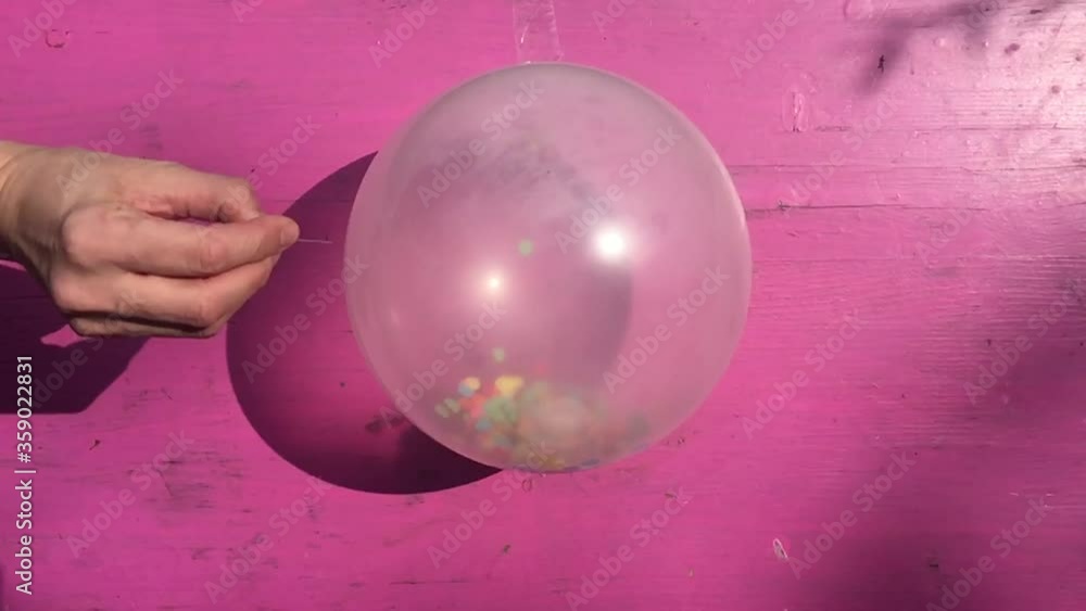confetti balloon pop popping in slow motion with confetti inside