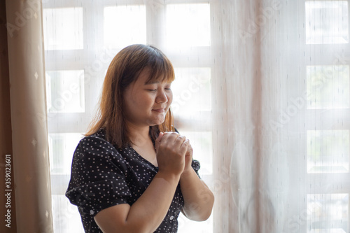 Asian woman praying with believe in God.