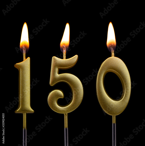 Gold birthday candles on black background, number 150