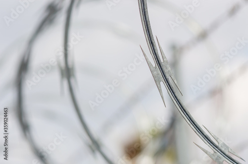 Razor concertina wire against white sky