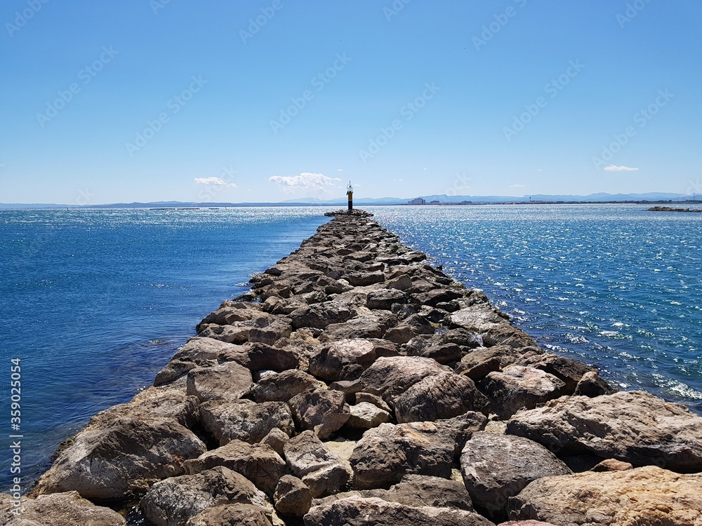 Stone pier at sea in Roses city Spain
