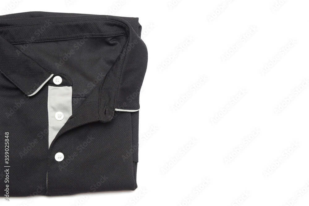 Folded blank black polo shirt with three white buttons. Polo shirt isolated on white background. Men's clothing.Folded clothes. Folded blank black polo shirt with three white buttons. Polo shirt isolated on white background. Men's clothing.Folded clothes.