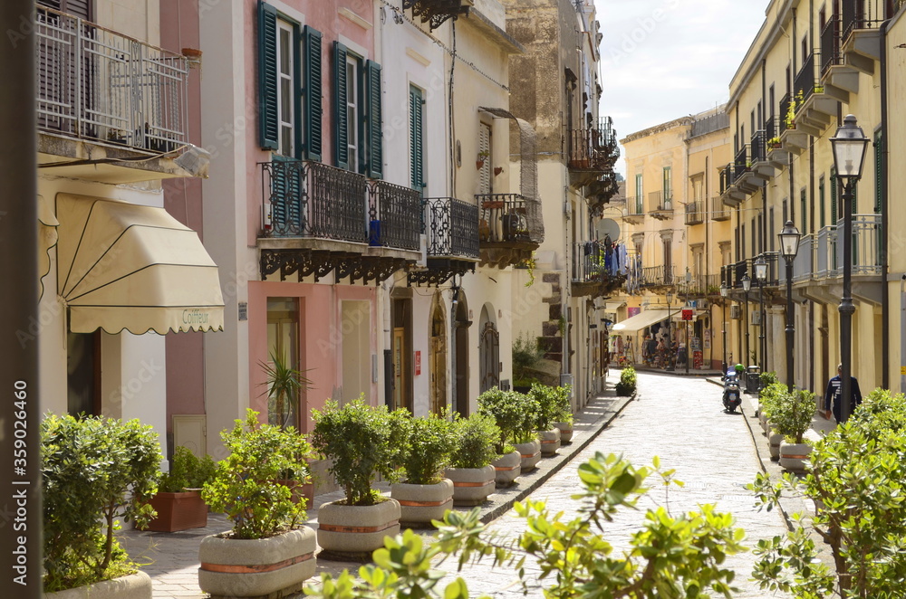 Lipari, Sicily. Aeolian island. Italy. 11/10/2019 - The usual street of an Italian resort. Pastel colors, lots of plants, balconies and pretty windows