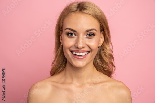 Close Up portrait of attractive  nude  girl with healthy white teeth isolated on pink background  perfection  wellness  wellbeing  restoration concept