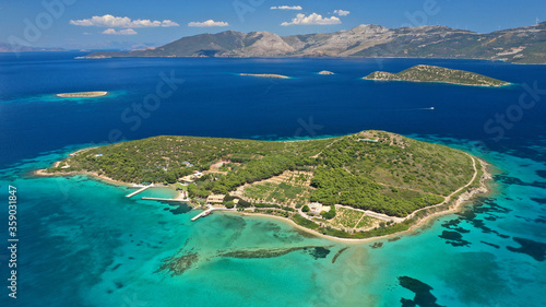 Aerial drone photo of beautiful paradise island of Tragonisi in gulf of of Petalioi or Petalion and island complex that forms a blue lagoon  South Evoia island near Marmari  Greece
