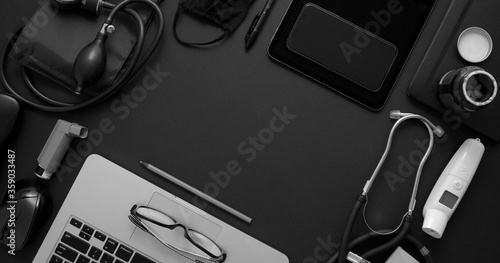 Doctor desktop concept. Various medical tools and accessories placed on black background table