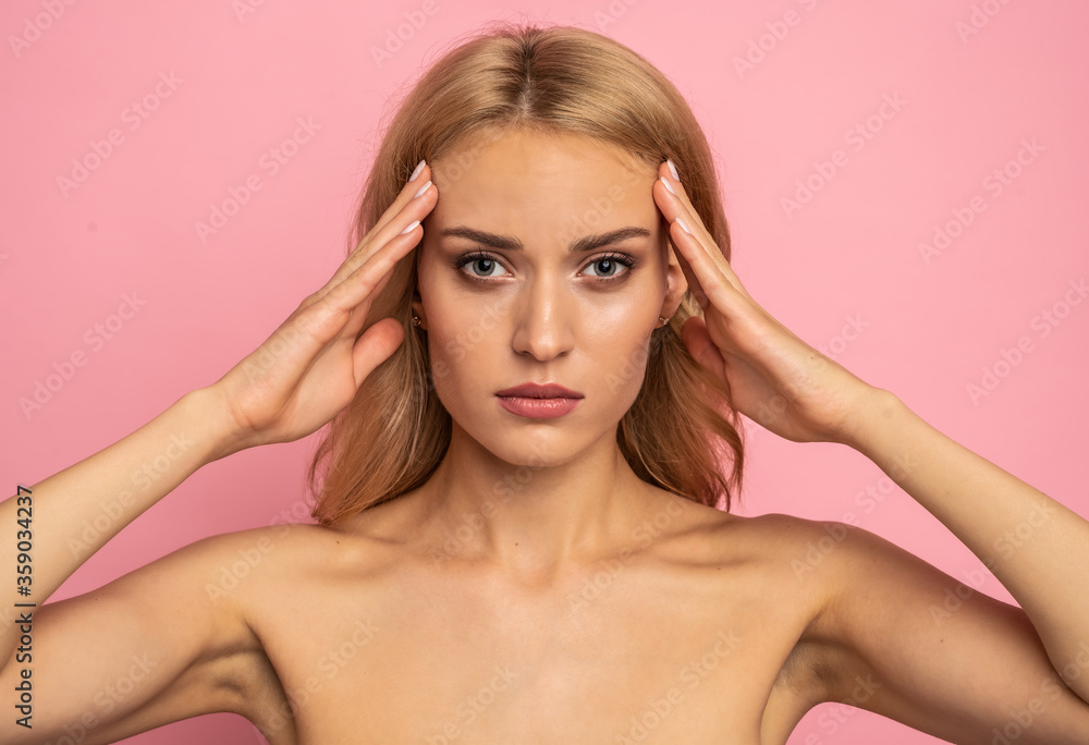 Portrait of pretty, healthy girl with smooth soft skin thinking about tightening near eyes, ready for plastic surgery treatment, isolated on pink background Portrait of pretty, healthy girl with smooth soft skin thinking about tightening near eyes, ready for plastic surgery treatment, isolated on pink background