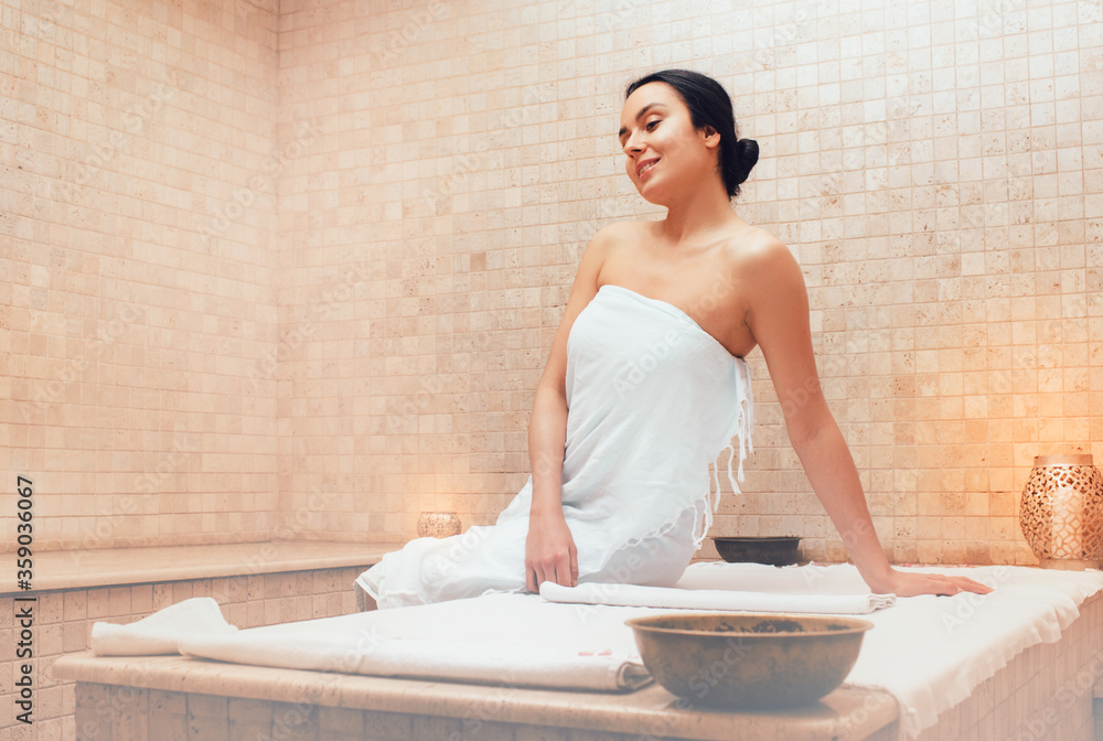 Ταπετσαρία Beautiful mixed race woman sitting on a marble massage table in a hammam