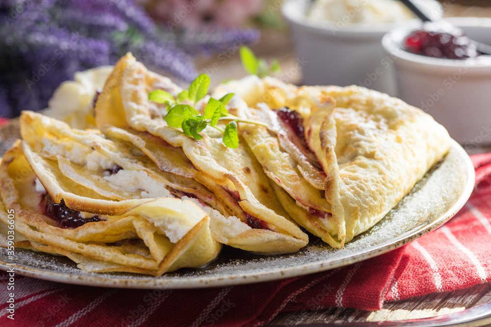 Crepes with ricotta cheese and blackcurrant jam. Crepes with ricotta cheese and blackcurrant jam.