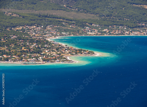 Panoramic view of the Greek village and the beautiful Psatha beach in the Corinthian Gulf of the Ionian sea in Greece on a Sunny summer day photo