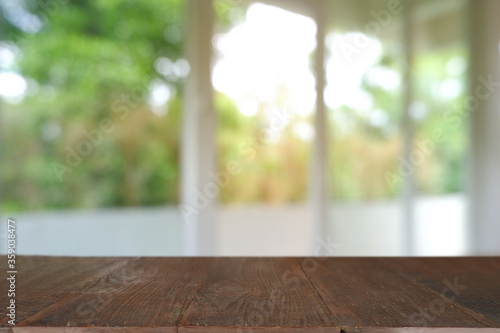 Empty wooden table in front of abstract blurred Cafe  restaurant  house interior. For montage product display or design key visual layout - Image
