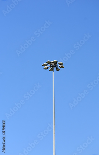 lamp post against blue sky with multiple led fixtures