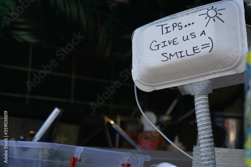 Tips sign at market food stall