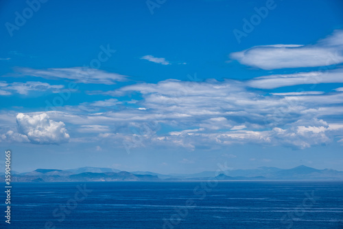 Blue sea and sky background, blue shades and white clouds © Rawf8