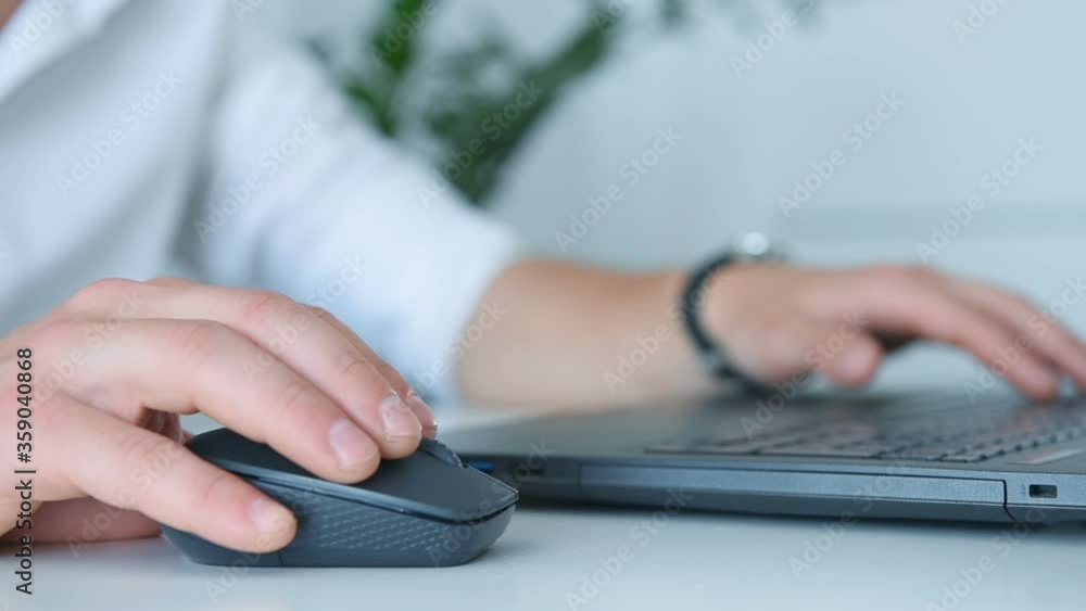 Businessman Sitting In Office And Using Financial Report On Laptop Computer. Occupation and worker concept. Businessman Sitting In Office And Using Financial Report On Laptop Computer. Occupation and worker concept.