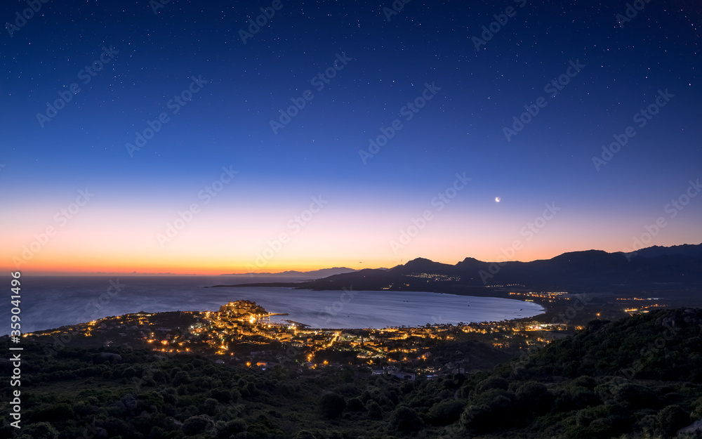 Obraz premium Moon rising over Calvi Bay in Corsica