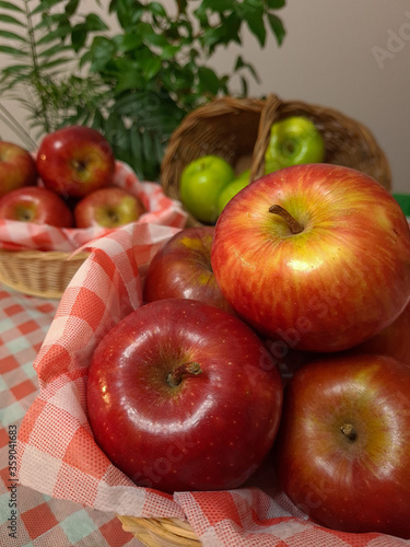 Very delicious and healthy apples, displayed in a beautiful basket for a pleasant picnic.