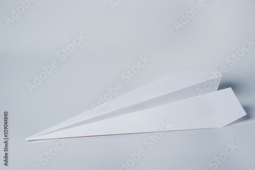 Paper airplane on a white background. Origami paper toy