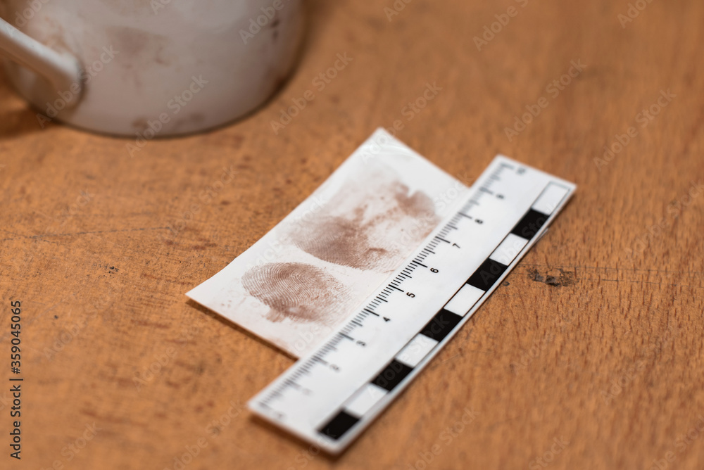 paper ruler and fingerprints on a sheet in the investigator's office. Fingerprint police uniforms. Forensic-medical examination