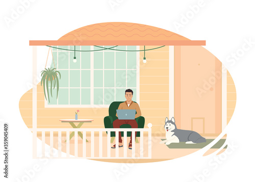 Male freelancer working in a laptop on the terrace with a dog