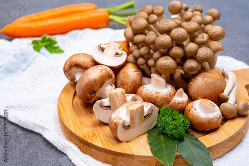 Fresh ingredients for tasty vegetarian mushrooms soup, brown champignons, buna shimeji, carrots