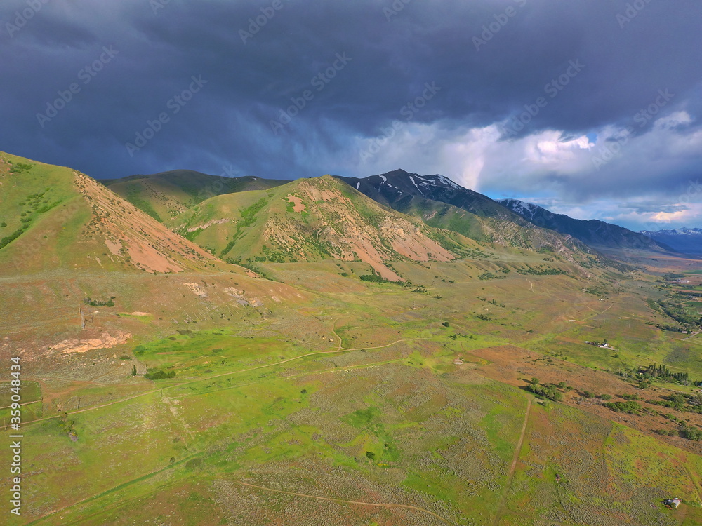 Drone view of Wellsville Mountains in Utah during thunderstorm 