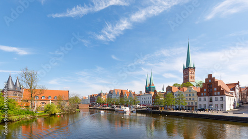 Panorama of city Lübeck with Holsten Tor, churches and river Trave