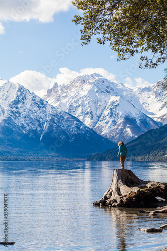 A young woman enjoying some superb views over a lake and some mountains in Patagonia near Bariloche in Argentina.