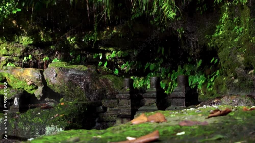 sharp rocks with moss in the jungle and drops of water falling on stones sharp rocks with moss in the jungle and drops of water falling on stones