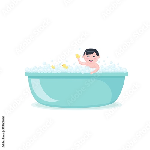 Happy baby taking a bath with yellow ducks, smiling boy in bubble bath, kid playing in the foam tub