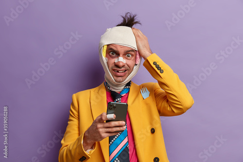Bilde på lerret Frustrated puzzled man takes revenge from someone, keeps hand on head, gets stra