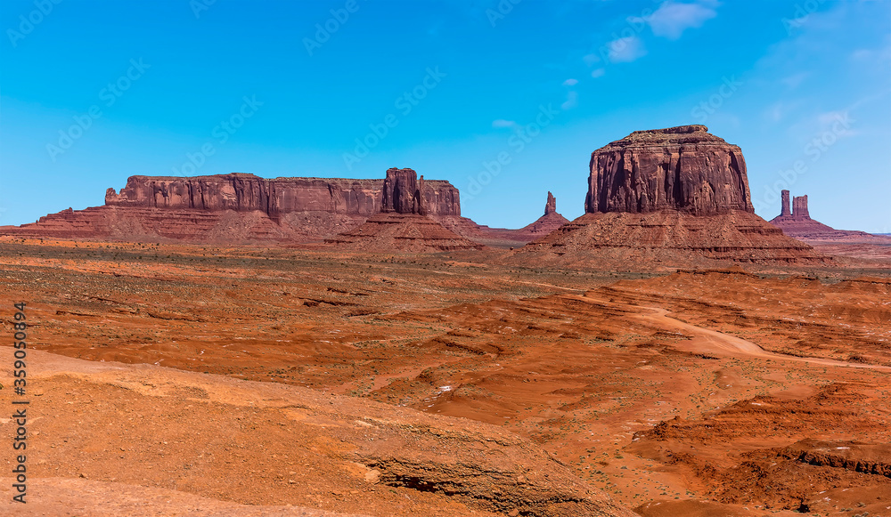 A panorama view of  Merrick Butte, Elephant Butte, East Mitten Butte and West Mitten Butte in Monument Valley tribal park in springtime