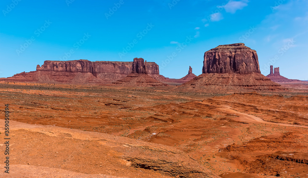 A panorama view of Merrick Butte, Elephant Butte, East Mitten Butte and West Mitten Butte in Monument Valley tribal park in springtime A panorama view of Merrick Butte, Elephant Butte, East Mitten Butte and West Mitten Butte in Monument Valley tribal park in springtime