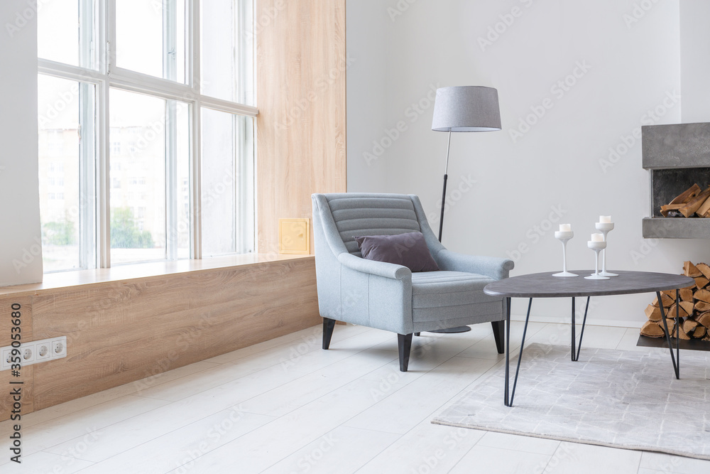 Luxury fashionable modern design studio apartment with a free layout in a minimal style. very bright huge spacious room with white walls and wooden elements. sitting area with fireplace Luxury fashionable modern design studio apartment with a free layout in a minimal style. very bright huge spacious room with white walls and wooden elements. sitting area with fireplace