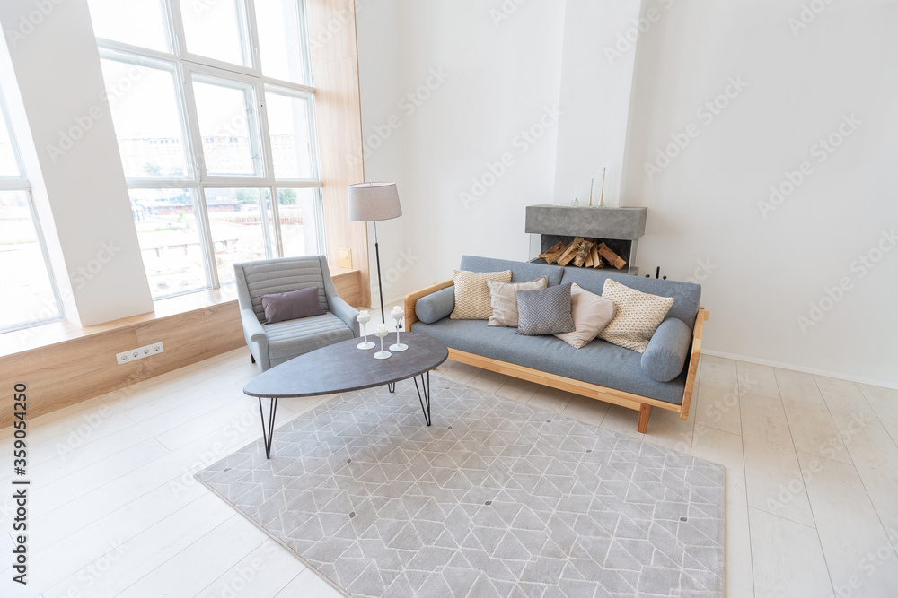 Luxury fashionable modern design studio apartment with a free layout in a minimal style. very bright huge spacious room with white walls and wooden elements. sitting area with fireplace Luxury fashionable modern design studio apartment with a free layout in a minimal style. very bright huge spacious room with white walls and wooden elements. sitting area with fireplace