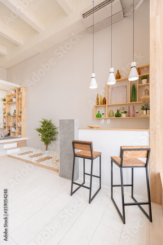 Luxury fashionable modern design studio apartment with a free layout in a minimal style. very bright huge spacious room with white walls and wooden elements. sitting area with fireplace