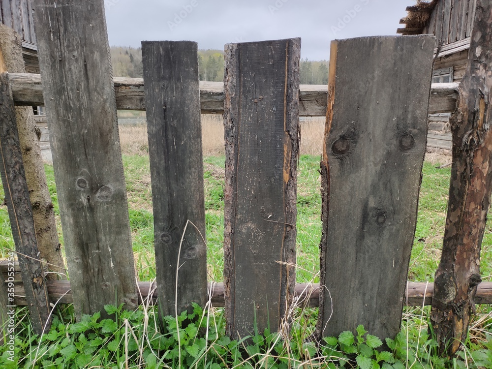 Fototapeta premium Fence from the boards. The texture of the old boards. Wooden elements of the fence.